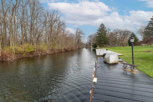 dock area with a water view and a lawn