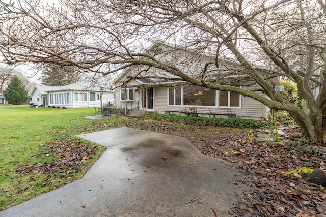 view of front facade with a patio and a front yard