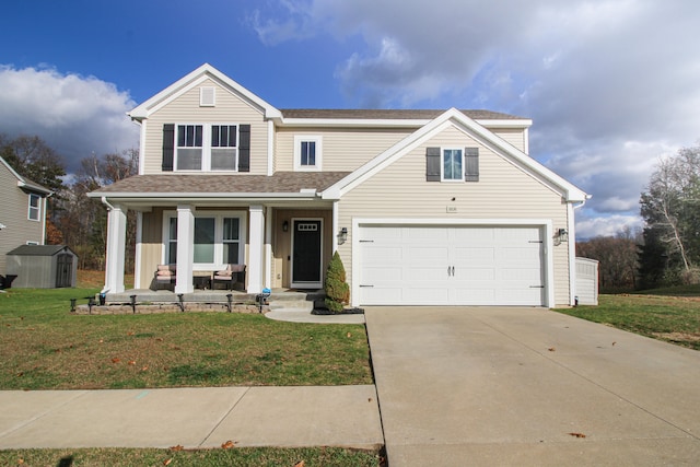 view of front of property featuring a front lawn, a shed, a porch, and a garage