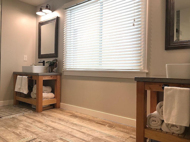 interior space featuring wood-type flooring, vanity, and plenty of natural light