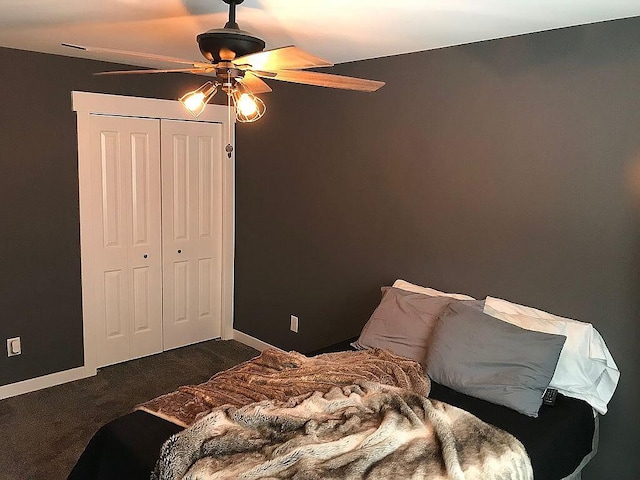 bedroom with ceiling fan, a closet, and dark carpet