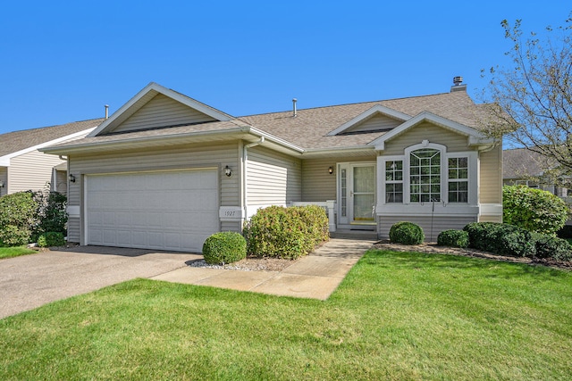 single story home featuring a garage and a front yard