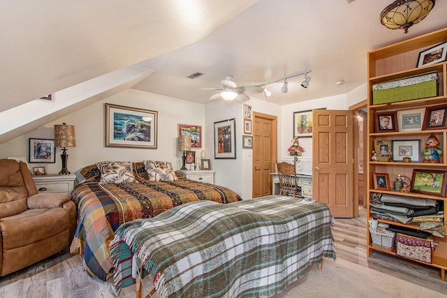 bedroom featuring ceiling fan, lofted ceiling, and light hardwood / wood-style floors