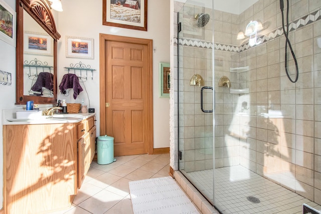 bathroom featuring tile patterned flooring, vanity, and a shower with door