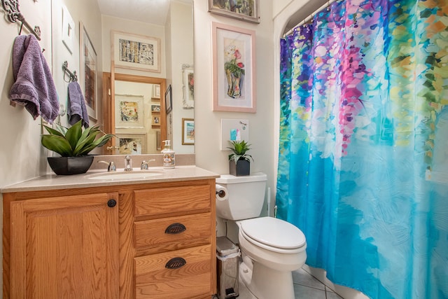 bathroom featuring vanity, tile patterned flooring, and toilet