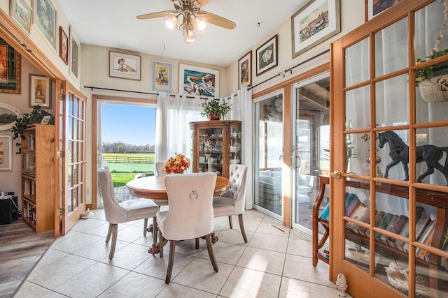 tiled dining space with ceiling fan