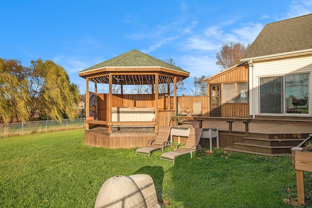 view of yard featuring a jacuzzi, a sunroom, a wooden deck, and a gazebo