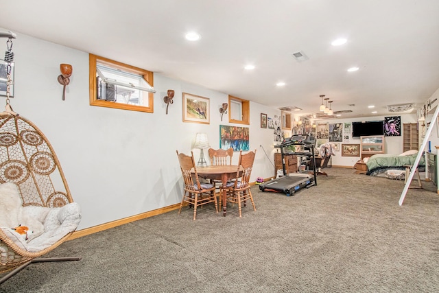 carpeted dining area with ceiling fan