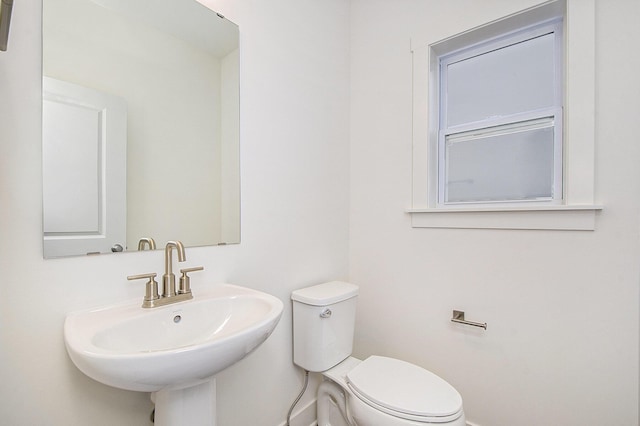 half bath featuring a sink and toilet