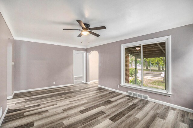 spare room featuring hardwood / wood-style floors and ceiling fan