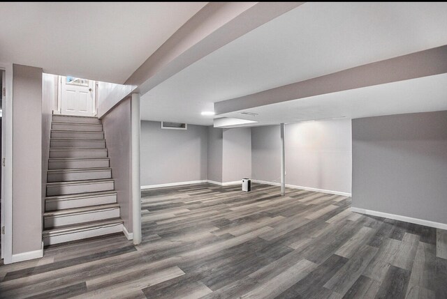 basement featuring dark hardwood / wood-style flooring