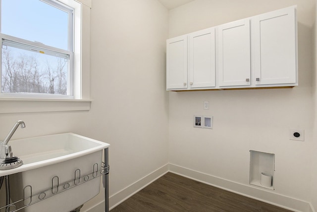 clothes washing area featuring cabinet space, baseboards, dark wood-type flooring, hookup for a washing machine, and hookup for an electric dryer