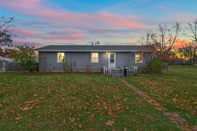 back house at dusk with a yard