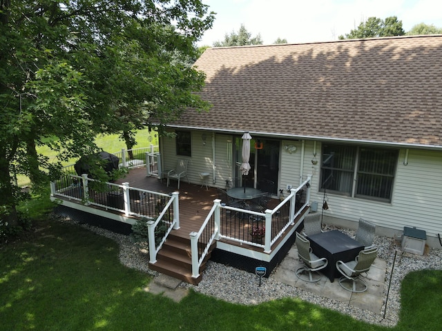 rear view of property featuring a patio area and a deck