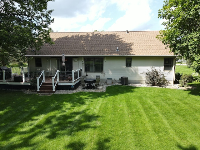 rear view of house with central AC, a yard, and a wooden deck