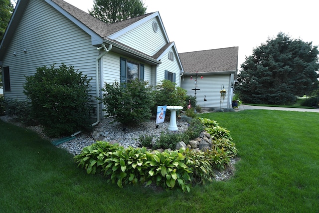 view of side of home with a lawn