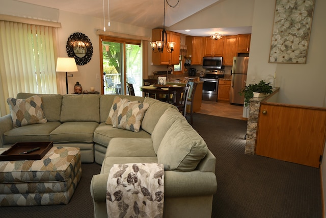 living room with an inviting chandelier, lofted ceiling, sink, and carpet