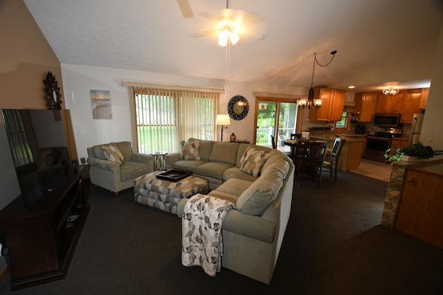 living room featuring dark colored carpet, lofted ceiling, and ceiling fan