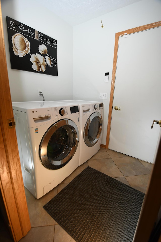 laundry room with separate washer and dryer and light tile patterned floors