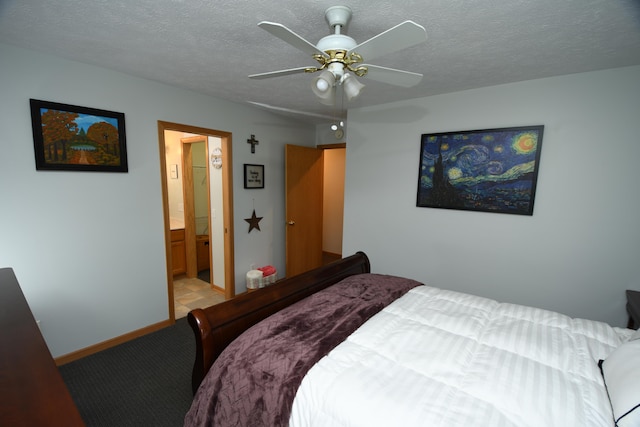 bedroom with ceiling fan, connected bathroom, and a textured ceiling