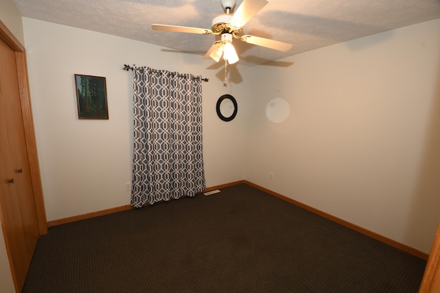 carpeted empty room with a textured ceiling and ceiling fan