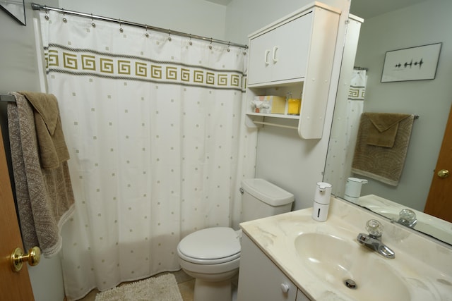 bathroom featuring walk in shower, vanity, tile patterned floors, and toilet