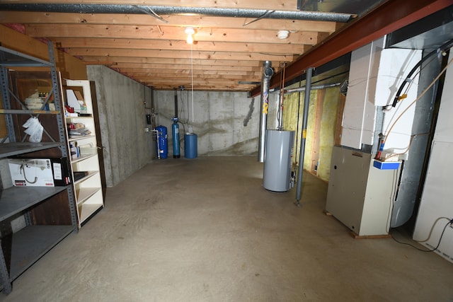 basement featuring water heater and heating unit