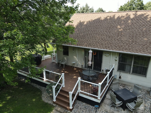 back of property with a wooden deck