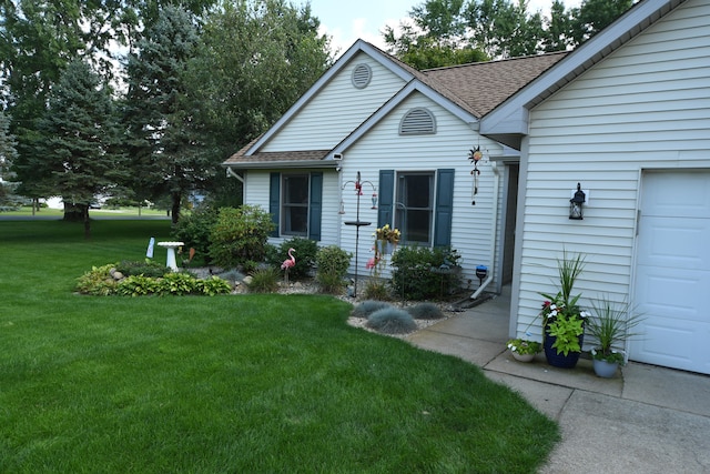 view of front of home with a garage and a front lawn