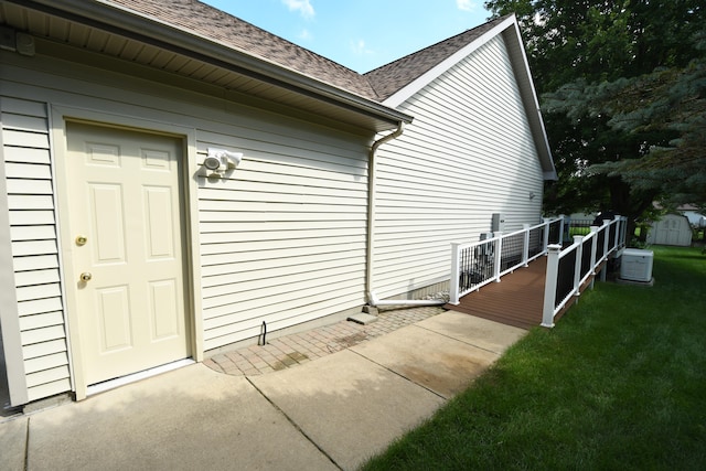 view of property exterior with a yard and a storage shed