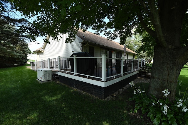 view of home's exterior with a deck, a lawn, and cooling unit