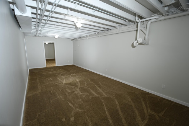 basement featuring dark colored carpet