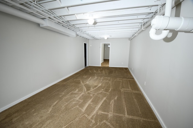 basement featuring dark carpet