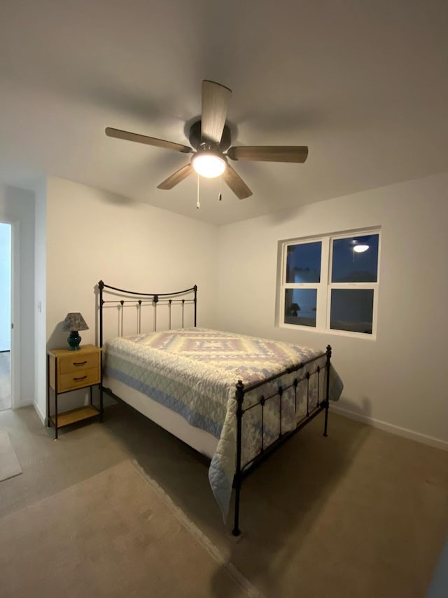 bedroom featuring ceiling fan and dark carpet