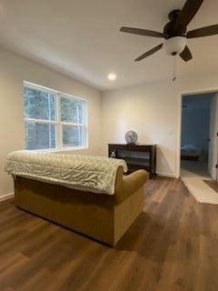 bedroom featuring ceiling fan and dark wood-type flooring