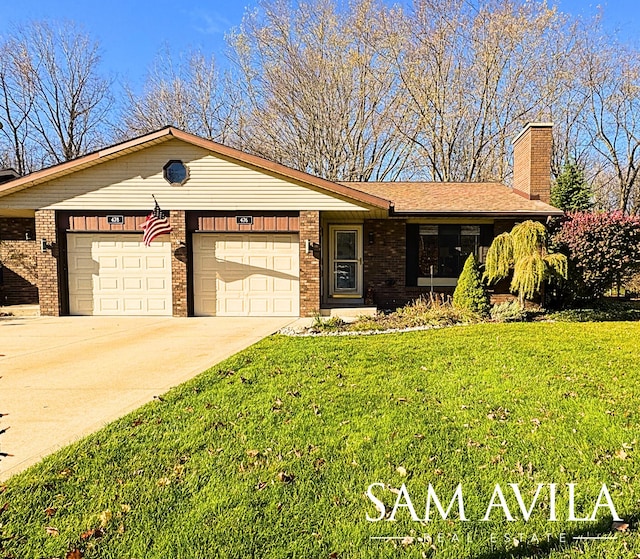 ranch-style house featuring a front yard and a garage