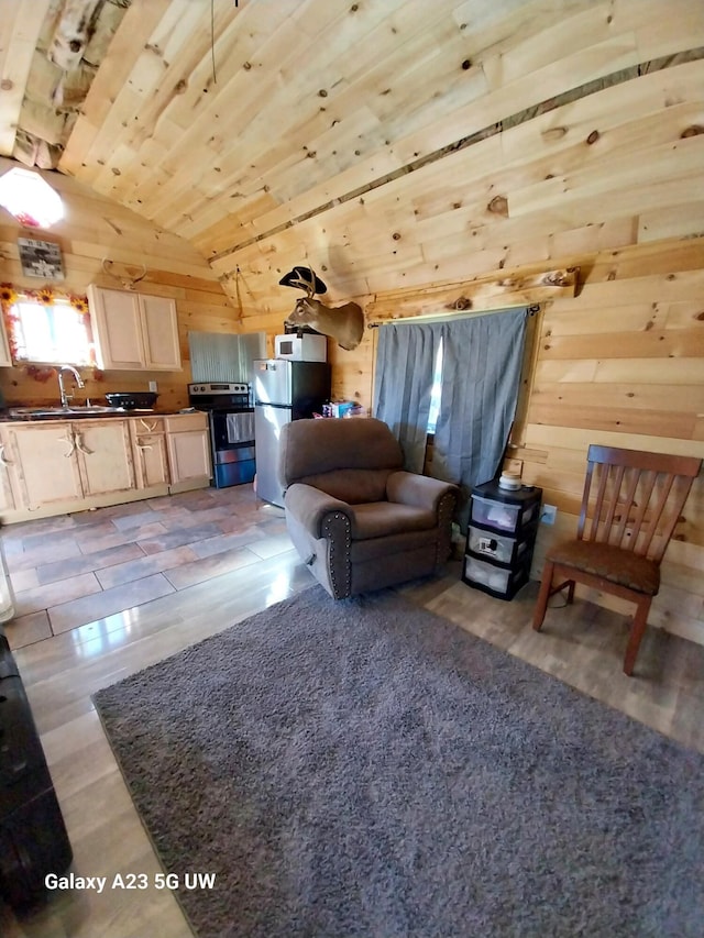 living room featuring sink, wooden ceiling, wood walls, light hardwood / wood-style floors, and lofted ceiling