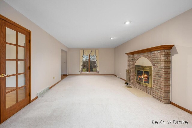 living room featuring carpet flooring and a brick fireplace