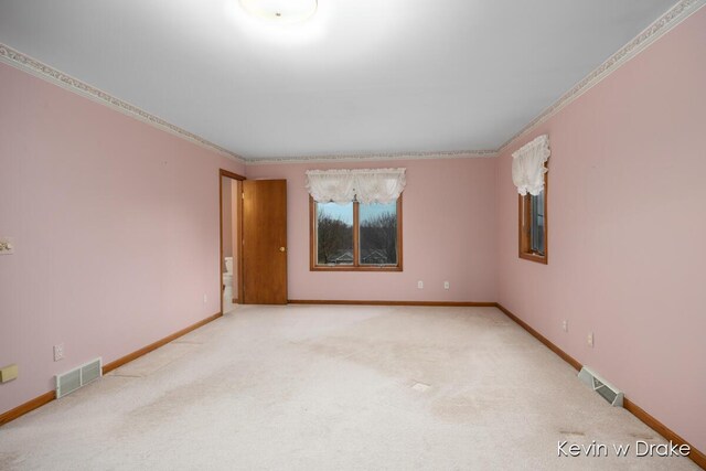 unfurnished room featuring ornamental molding and light carpet