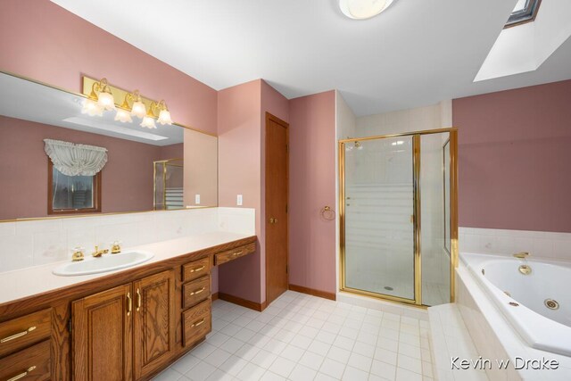 bathroom featuring tile patterned flooring, shower with separate bathtub, and vanity