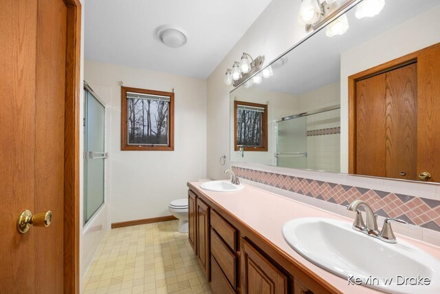 full bathroom featuring shower / bath combination with glass door, vanity, backsplash, and toilet