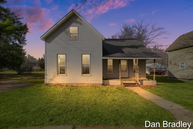 view of front facade with a lawn and covered porch