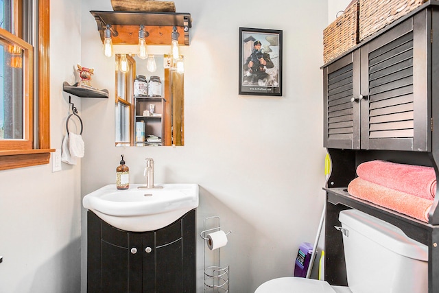 bathroom featuring vanity and toilet