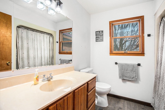 bathroom featuring hardwood / wood-style floors, vanity, and toilet