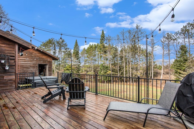 wooden terrace featuring a hot tub