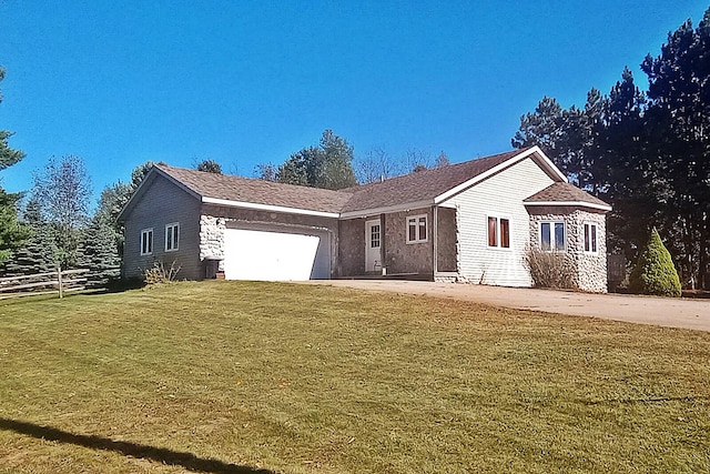 single story home featuring a garage and a front yard