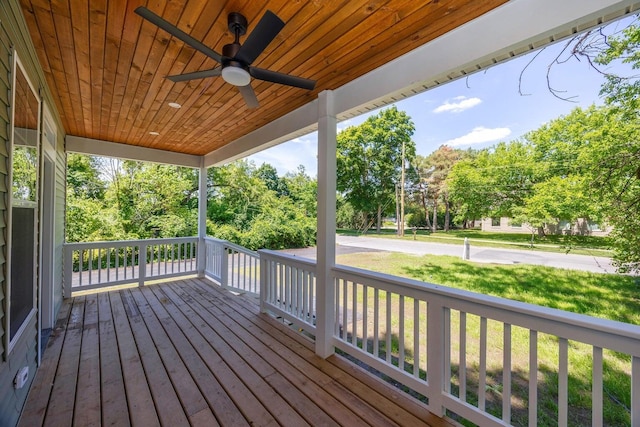 deck with covered porch, a yard, and ceiling fan