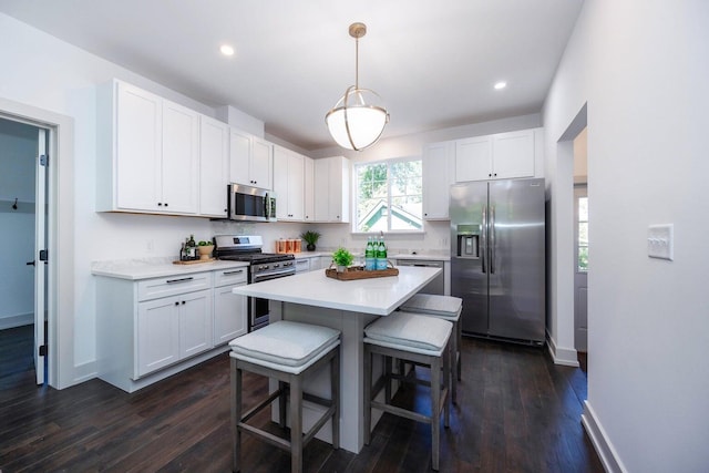 kitchen with white cabinets, pendant lighting, and appliances with stainless steel finishes