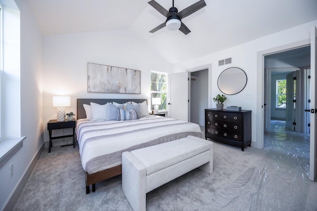 bedroom featuring carpet, vaulted ceiling, multiple windows, and ceiling fan