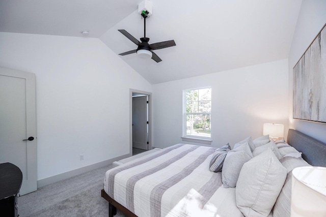 bedroom featuring ceiling fan, lofted ceiling, and light carpet